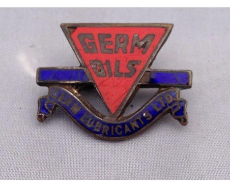 A Germ Oils Germ Lubricants Limited red and blue enamel lapel badge.
