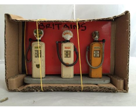 A set of three Britains model petrol pumps on oval base, for Shell, BP and National Benzole.