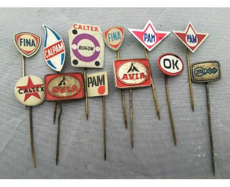 A collection of 12 petrol and oil motoring stick pins including Fina and Caltex. 