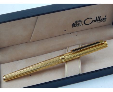 A gold plated Colibri pen, with engine turned design, boxed.