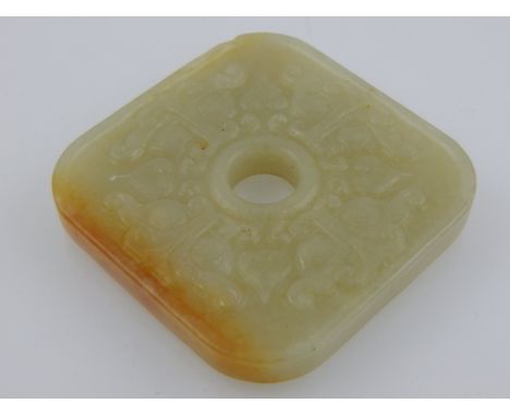 A Chinese square jade pendant, relief decorated with stylised flowers. W. 5.5cm