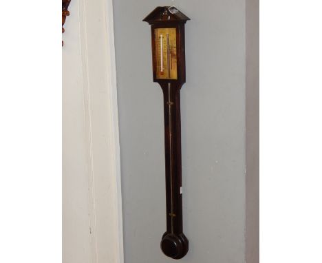 A mid 20th century George III design mahogany stick barometer, with broken arch pediment over an engraved brass scale marked 