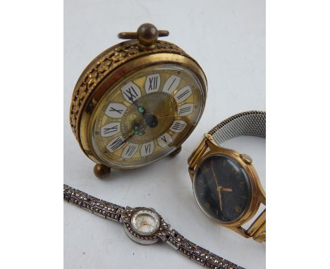 A German brass desk alarm clock, the round dial with Roman numerals, together with a gentleman's Ingersoll wristwatch, the bl