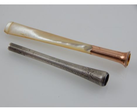 A 9 carat yellow gold and mother of pearl cigarette holder, together with a white metal cigarette holder of engine turned des