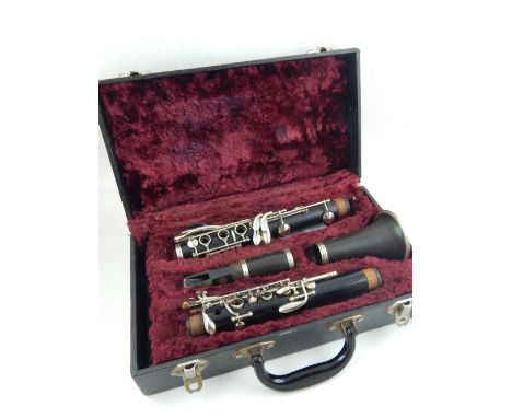 A mid 20th century Buisson four section clarinet, wood body with faux horn bell, serial number 343216, cased.