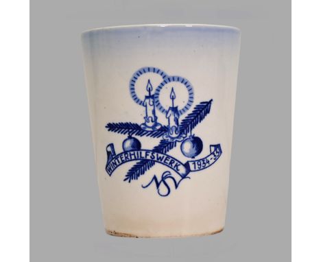 Glazed stoneware mug featuring a motif of a fir branch with a bauble and burning candles, accompanied by the lettering "Winte