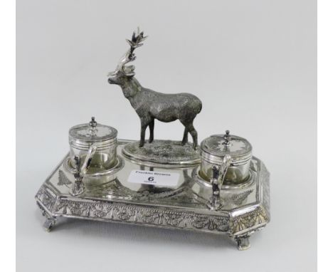 Late 19th / early 20th century Epns inkwell, surmounted with a stag and with fern bright cut decoration, with two glass inkwe