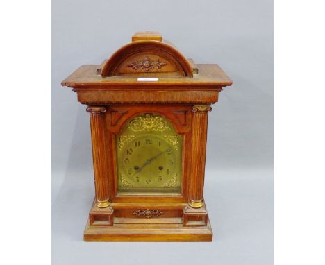 Oak cased mantle clock, the domed top over a brass dial with Arabic numerals flanked by pilasters on a rectangular plinth bas