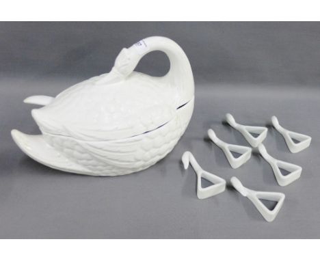 White glazed swan shaped tureen and cover with ladle and a set of twelve swan pottery napkin rings, (a lot) 
