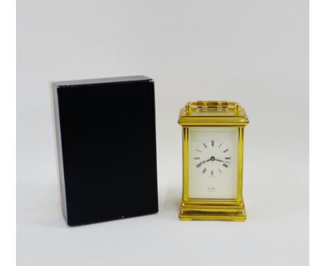 St James of London gilt brass carriage clock, the enamel dial with Roman numerals, on plinth base, with carry handle to top, 