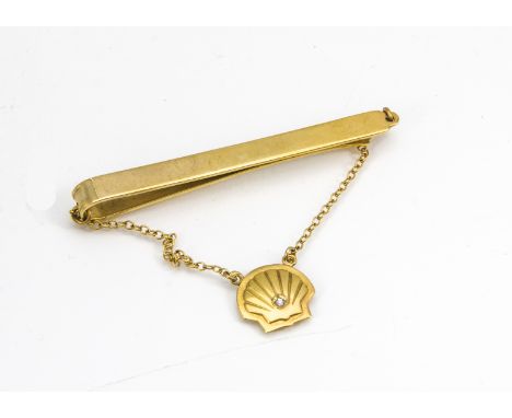 A 9ct gold and diamond set tie slide, from Shell Oil, the plain slide supporting a shell pendant set with eight cut diamond, 