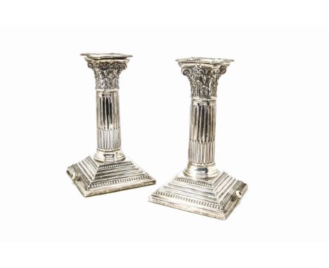 A pair of Edwardian silver column candlestick lamp bases, the filled short Corinthian columns on square bases, Birmingham 190