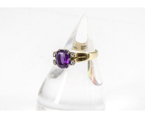 A contemporary 18ct gold and diamond amethyst set dress ring, the cushion cut amethyst in claw setting flanked by two eight c