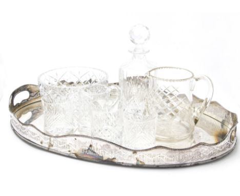 A large Edwardian Sheffield plate oval twin handled tray, together with a glass decanter and stopper, water jug, tankard, thr