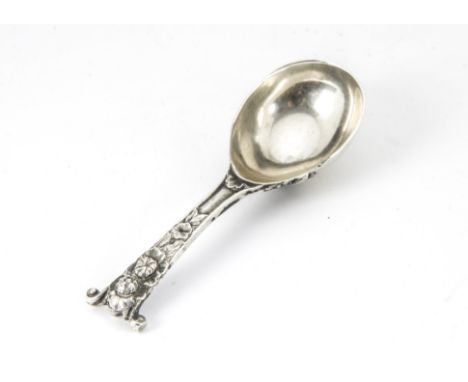 A Regency period silver tea caddy spoon, in the manner of William Burwash & Richard Sibley, with engraved family crest to und