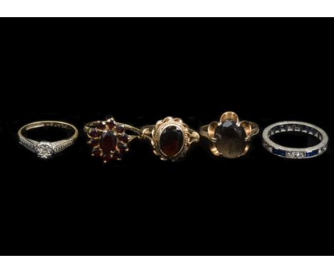 A collection of gem set rings, including an 18ct gold and platinum diamond solitaire, a garnet cluster ring, a smoky quartz r