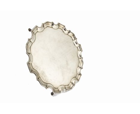 An Edwardian silver salver by GJ DF, having pie crust rim on three supports, London 1904, no engraving and overall good condi