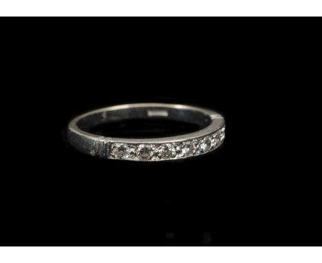 A diamond 18ct gold half hoop eternity ring, the brilliant cuts in channel setting on a white gold shank, ring size O, 2.8g 