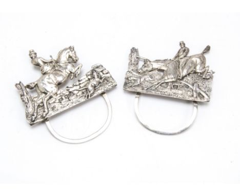 A pair of late Victorian silver hunting themed menu holders by SJ, modelled as a male and female horse rider jumping with a h