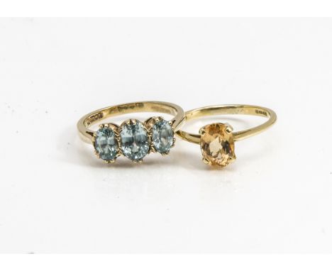 A 9ct gold three stone zircon dress ring, the oval mixed cuts in claw settings, ring size L together with an 18ct gold sherry