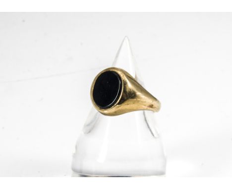 A contemporary 9ct gold and onyx gentleman's signet ring, the oval onyx slightly raised on a yellow gold mount and shank, rin