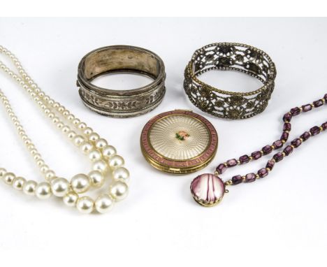 A white metal Victorian cuff bangle with engraved floral design, together with a base metal pierced bangle, a gilt metal enam