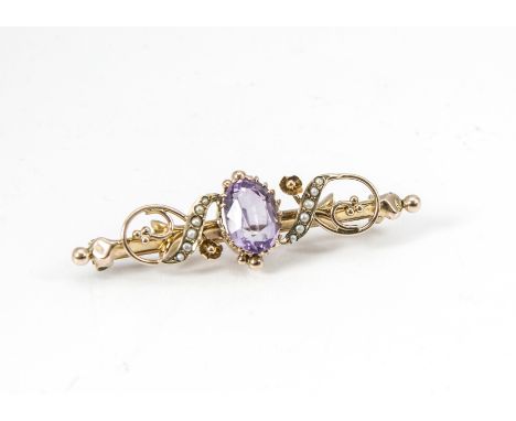 A 9ct gold amethyst and seed pearl bar brooch, the oval mixed cut amethyst in claw setting flanked by scroll set half cut see
