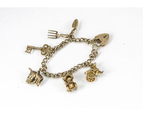 A 9ct gold curb link, padlock clasp charm bracelet, mounted with five charms comprising a trowel and fork, key, horse's head,
