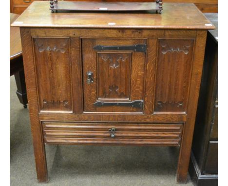 A joined oak cupboard, late 19th/early 20th century, carved overall with quatrefoil carving, the front with a single cupboard