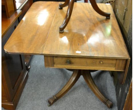 A George IV mahogany sofa table, second quarter 19th century, with two rounded drop leaves above one real and one sham drawer