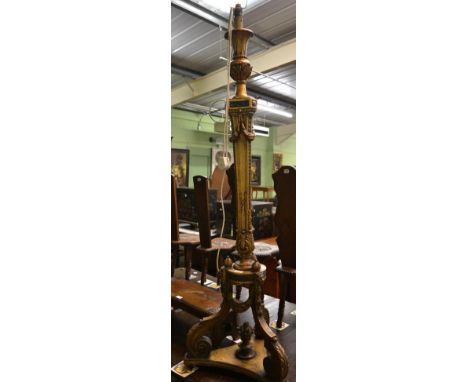 Carved gilt wood standard lamp on triform base