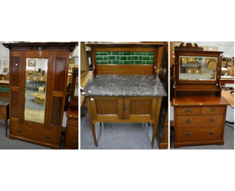 An early 20th century mahogany three piece bedroom suite comprising a marble topped and tile backed washstand, a mirror front