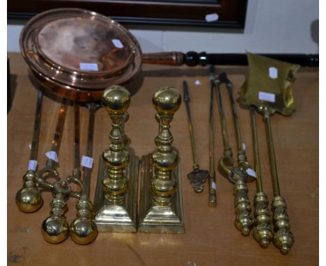 A pair of brass andirons, two sets of three fire tools and an additional two fire pokers and a copper bed warmer 