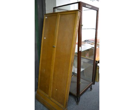 Early 20th century mahogany framed standing shop display cabinet, glazed to the top and all four sides, on shaped cast iron f