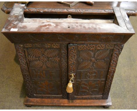 Carved oak double door cabinet enclosing one shelf 