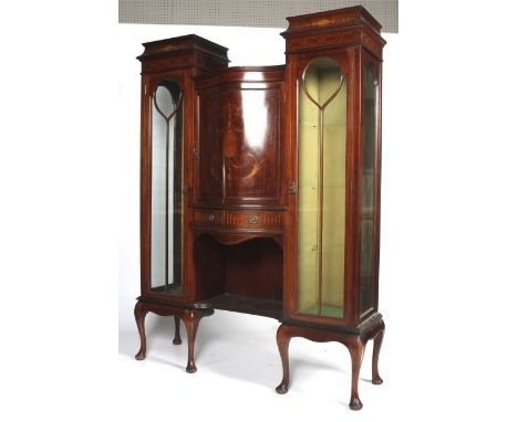 An Edwardian mahogany marquetry inlaid glazed display cabinet. The central cupboard of serpentine form inlaid with neo-classi