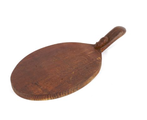 A workshop of Robert Mouseman Thompson (Kilburn) oak oval bread board. The handle carved with the signature mouse, 37cm long