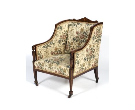 A late 19th century rosewood and marquetry inlaid armchair. The shaped cresting inlaid with a neoclassical vase, upholstered 