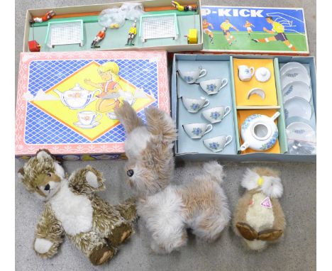 Three soft toys including one Clemens made in West Germany, a vintage German Tipp-Kick football game and a dolls tea service