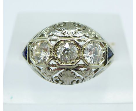 An 18ct white gold, Art Deco diamond and sapphire ring, set with three diamonds and two triangle shaped sapphire shoulders, 3