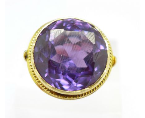 A yellow metal and purple stone ring, tests as 18ct, 11.4g, R, stone 17mm
