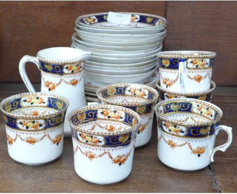 An Edwardian part tea set, one cup a/f