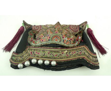 A Chinese silk embroidered ceremonial scholars hat, early 20th Century, ruyi scroll borders edged by yellow metal on a black 