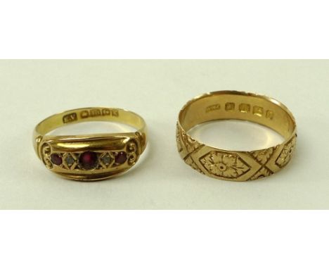 An 18ct gold wedding band with engraved decoration of flowers inside medallions, size N, and a 18ct gold, ruby and diamond fi