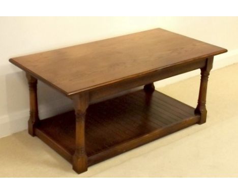 A modern oak veneered coffee table, in the early Georgian style, with rectangular surface, turned supports joined by a floor 