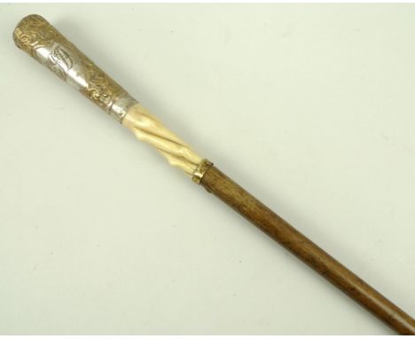 A walking stick, the straight handle with ivory base and embossed gilt metal to top, monogrammed EJD, 88cm. 