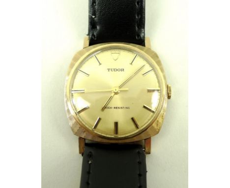 A gentleman's vintage 9ct gold Tudor wristwatch, with baton numerals to the gold coloured face, on a black leather strap, wit