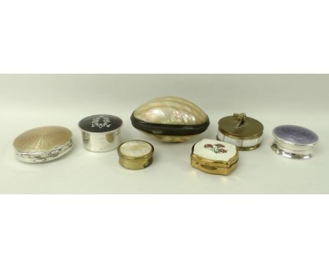 A group of pill boxes comprising three silver with a purple enamel lid, gold enamel lid, and tortoiseshell lid with floral de