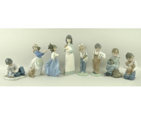 A collection of Nao figurines comprising a female with dog, 500, female with dove, 525, boy with toy train, 555 1, boy with p