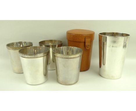 A Victorian silver beaker, London 1886, makers mark indistinct, 7.66toz, 8 by 11.5cm, and a set of four post war silver hunti
